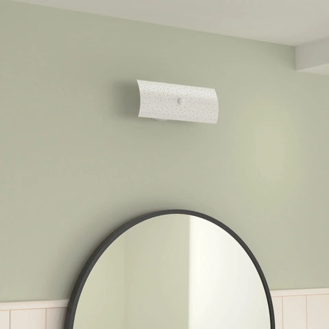 Lit Dual Socket Vanity Light Fixture With Frosted Glass Shade For Wall Mount Bathrooms, shown above round mirror on mint wall.
