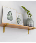 Premium Corner Shelf Brackets For Floating Wall Shelves and Rustic Industrial L Shape Supports with a Sleek Matte Black Finish holding framed art.
