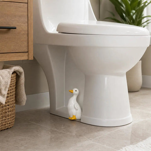 Total Bath Refresh With These Straight Up Cute Ceramic Duck Toilet Bolt Caps Set Of Two Standing Screw Covers Featuring Easy Peasy Setup And Real Deal Rust Protection, shown near toilet.