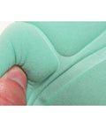 Close-up of green fabric being stretched by a hand, highlighting its flexibility and texture.