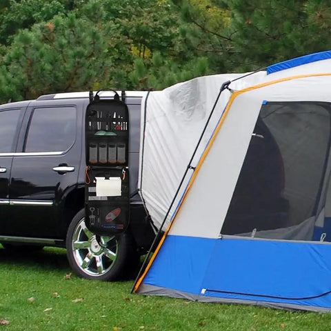 High Capacity Camp Kitchen Organizer Bag With Hanging Hooks And Paper Towel Holder Waterproof Multi Pocket Portable Storage attached to car next to camping tent.