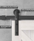 Close-up of Bypass Sliding Barn Door Hardware Track With Bent Hanger System shown installed on a wood door.