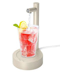 Beige 5 Gallon Water Dispenser For Desktop Use dispensing water into glass, USB-C fast charging, electric pump with press button.