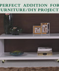 Four antique-brass swivel caster wheels installed on a white rectangular coffee table.