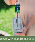 Person holding spike and block from Landscape Edging Kit With Faux Stone Blocks For Lawn Borders And Flower Beds 10 Pack