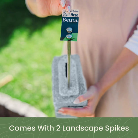 Person holding spike and block from Landscape Edging Kit With Faux Stone Blocks For Lawn Borders And Flower Beds 10 Pack