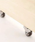 Low Profile 1 Inch Silent Ball Bearing Casters 4 Pack Mini Furniture Wheels For Beds And Drawers installed on a light wood piece.