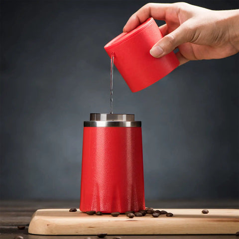 Kickstart Your Morning Anywhere With This Portable Manual Coffee Maker Equipped With Integrated Grinder And Bean Compartment Ideal For Camping Runs And Highway Hauls Pull Smooth Rich Brews Straight To Mug Effortless, red coffee maker pouring water.