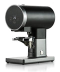 58mm Automatic Espresso Coffee Tamper With Adjustable Height And Custom Pressure Control, sleek black and silver design, sits on countertop.