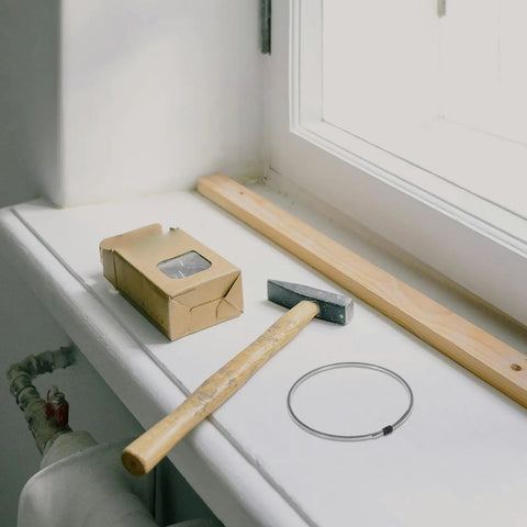 Upgrade Your Setup With High Quality Nickel Chrome Heating Wire Heat Seal Strips on a windowsill with a hammer and wood.