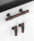 Ten Pack Three Inch Walnut Wood Grain Cabinet Pulls In Matte Black Metal Drawer Handles For Dresser And Cupboard Durable Wood Grain Finish Five Inch Total Length Three Inch Hole Centers For Easy Mounting installed on white cabinet.