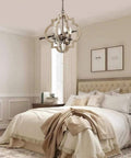 Handmade Wood Farmhouse Orb Chandelier with four lights, openwork quatrefoil frame, distressed brown wood in cozy bedroom setting.
