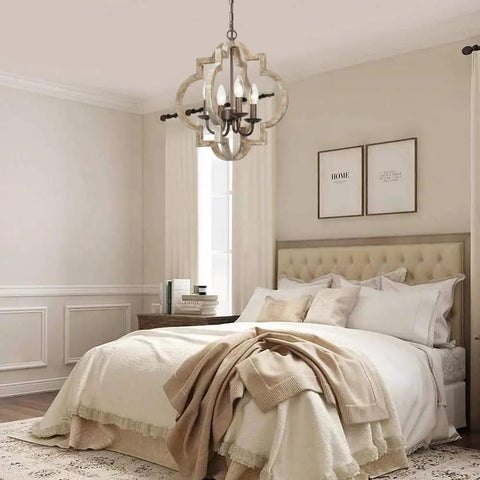 Handmade Wood Farmhouse Orb Chandelier with four lights, openwork quatrefoil frame, distressed brown wood in cozy bedroom setting.