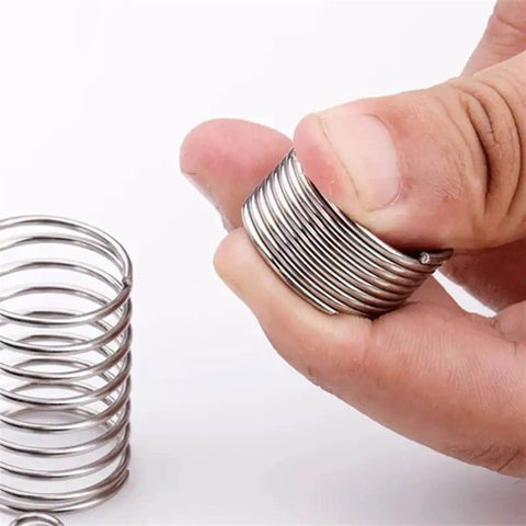 Hand holding Extension Compression Springs Kit, 10 Piece Set With Wire Diameters From 0.3 To 1.2 Mm, Outer Diameter 5 Mm, 50 Mm Length, 304 Stainless