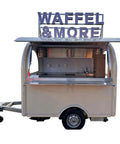 Custom food vending trailer with opened side, featuring built-in refrigeration, deep sink, and lockable storage for mobile eatery.