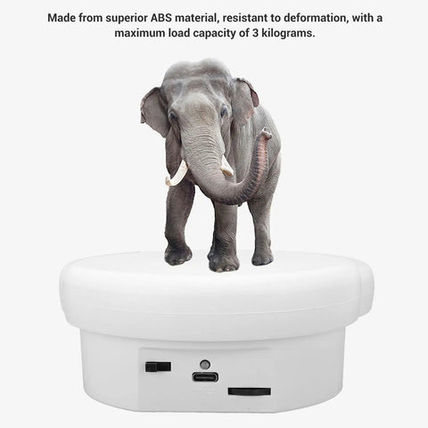 Stunning Electric Rotary Display Stand With 360 Degree Rotation For Jewelry Photography showing an elephant on a white motorized turntable.