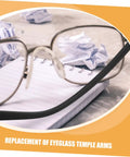 Close-up of eyeglasses with black metal temple, paper, and focus keyword: 2 Pairs Spectacle Temple Replacement Arms For A Comfortable Fit And No Sweat Install Durable Design For Quick Eyewear Repairs Universal Metal Eyeglass Temple Replacements For Most Glasses.