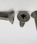 Close-up of Beefy Stainless Steel Trailer Floor Screws 5/16-18 X 1-1/4 showing threaded body and star head design.