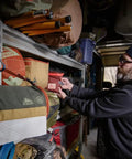 Man organizing shelves with Spill Ender 3 In 1 Paper Towel Holder For Cars And Campsites hanging, waterproof and compact.