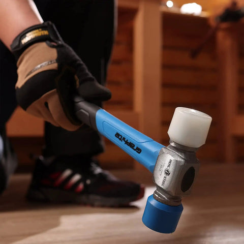 Double Face Rubber Mallet 12 Oz with White Nylon Head and Blue Soft Face in hand, graphite core handle, showing use.