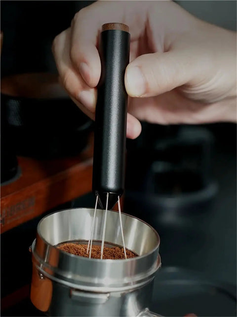 No Fuss WDT Needle Tool For Espresso Brewing retractable telestopic stirrer leveling coffee grounds in a portafilter basket.
