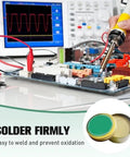 Low Temp Solder Flux Paste For Precision Electronics Repair No Clean Lead Free Liquid Solder Paste in use on a circuit board.