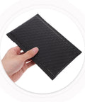 Hand holding Black Padded Bubble Mailer Envelopes 12x18, showcasing texture and size for small business shipping and jewelry protection.