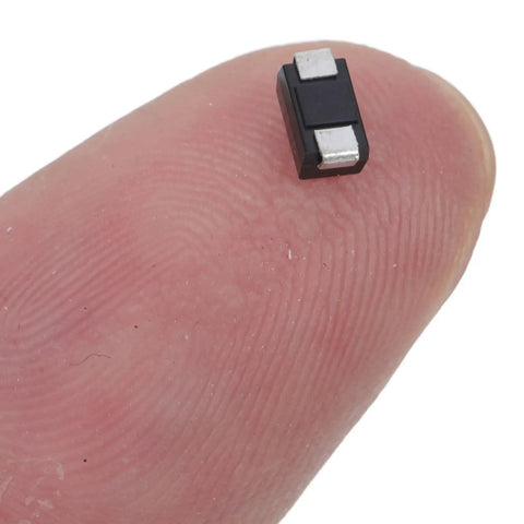 Small AC to DC rectifier diode on fingertip, part of Top Shelf Rectifier Diode 100 Piece Assortment Kit Heavy Duty Modules.