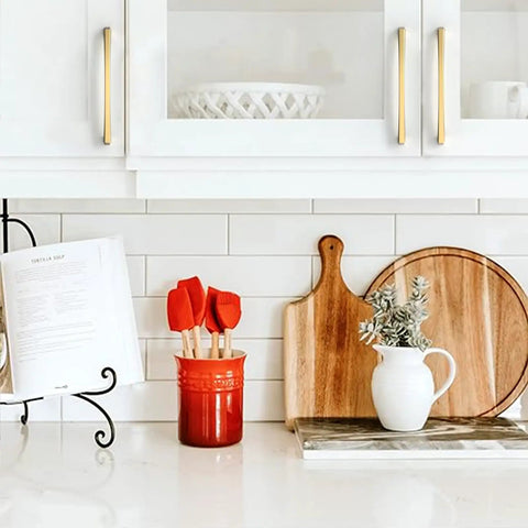 10 Pack 7.5 Inch Champagne Bronze Cabinet Pulls on white kitchen cabinets with red utensils and wooden decor