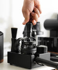Hand using Planetary Needle Distributor Tool 51mm V3 for Espresso WDT Magnetic Base on coffee station