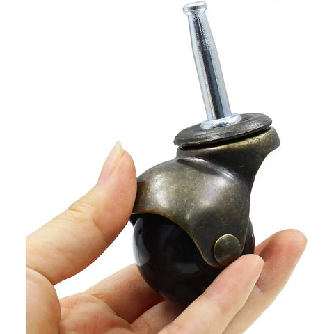 Antique Ball Caster Wheels For Furniture Smooth As Butter 1.5 Inch Diameter in hand showing dark ball and metal design.