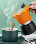 One Cup Stovetop Espresso Pot 150ml 5oz Glass Top Italian Coffee Maker For Italian And Cuban Café Brewing Travel Friendly Compact Design In Orange And Black pouring coffee into cup