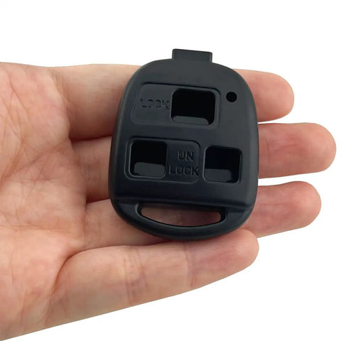 Hand holding Lexus Key Fob Shell Replacement Case, black keyless entry cover, no blade or circuit board inside.