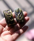 Hand holding ornate Tsuba Fuchi Kashira Menuki Set For Samurai Swords Upgrade Your Blade Setup With Alloy Guard Fits Tsuka Handle Ferrule