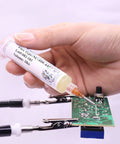 Hand using No Clean Flux Gel Paste for Soldering with Needle Dispensing Tool 559 ASM on electronic circuit board