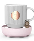 Electric Cup Warmer With Auto Shut Off Timer And Dual Temp Control Keeps Your Morning Brew Cozy On Your Desk With A Bright LED Display, featuring a gray ribbed mug and a pink coaster.
