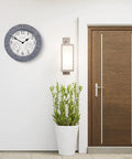 Wall-mounted All In One Outdoor Clock With Thermometer And Hygrometer Weather Station For Patio And Garden, 14 Inch Diameter In Gray Sandstone Finish near a door.