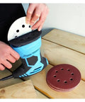 User changing 5 inch sanding disc on a blue electric sander, showcasing 8-hole hook and loop design for smooth finish.
