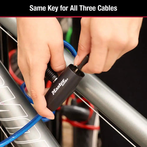 Person using Bike Lock Cable Set With Keys 3 Pack Keyed Alike 6 Ft Long Braided Steel Cables In Blue Green Red For Easy Security