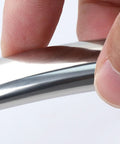 Close-up of fingers holding a Round Tube Stainless Steel Cabinet Handle For Drawers And Doors, Rustproof Pull Handle For Kitchen Cabinets.