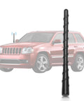 Close-up of a 7 Inch Car Radio Aerial Mast Replacement Fits Jeep Grand Cherokee Liberty Cherokee Trailhawk Latitude 2011 2012 2013 2014 2018 2022 Renegade Compass 4x4 FM AM Aerial Antenna Mast next to a Jeep vehicle.