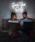 Couple under 'Good Vibes Only Neon Sign Wall Decor White Neon Light For Bedroom Bar Wedding Engagement Christmas Valentine’s Day Birthday Party 16.9 x 9 Inch Clear Acrylic Neon Strip Light' on wall