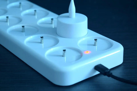 Close-up of charging base for Rechargeable LED Tea Lights Set Of 12 With Flameless Flicker In Amber Color Includes Frosted Holders