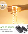 Hand holding 40ft Tunable White LED Strip Light With 1344 LEDs, Dimmable 3000K To 6500K, 24V Flexible Tape, RF remote beside adapter
