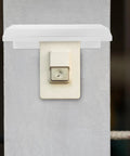 Rock Solid Outdoor EV Charger Cover Built Tough As Nails To Ward Off Rain And Grime With Smart Cross Ventilation on a wall socket.