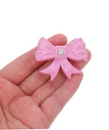 Super Dope Pink Bow Cabinet Pulls Pack Eight Piece Alloy Dresser Knobs For Girls Bedroom Refresh Easy Mount Cabinet Hardware in hand.