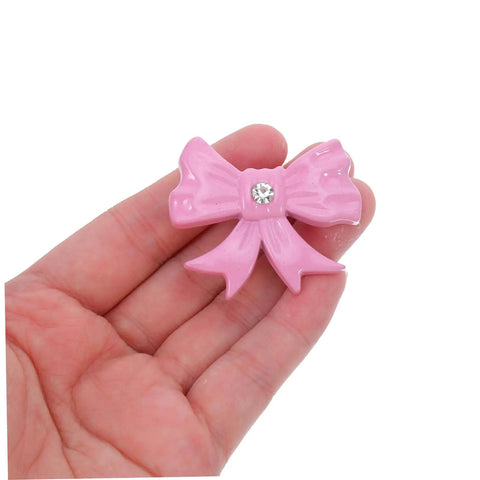 Super Dope Pink Bow Cabinet Pulls Pack Eight Piece Alloy Dresser Knobs For Girls Bedroom Refresh Easy Mount Cabinet Hardware in hand.
