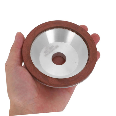 Top Tier Cup Shaped Diamond Grinding Wheel 100mm held in hand for stone metal and concrete sharpening tasks.