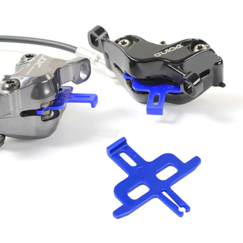 8 Piece Bike Hydraulic Disc Brake Bleed Blocks And Spacers Kit For Universal Calipers 2 And 4 Piston Compatible With Shimano Tektro TRP SRAM Avid Zoom And More Mountain And Road Bikes, showing blue bleed blocks inserted in calipers