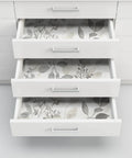Open drawers lined with Breezy Peel And Stick Botanical Wallpaper In Gray, Removable Self Adhesive Wall Covering For Easy Install.
